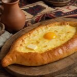 Georgian boat-shaped khachapuri filled with melted cheese, a soft egg yolk, and butter.