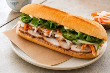 Vietnamese banh mi with pork, pate, pickled carrot and daikon, cucumber, cilantro, and jalapeno.