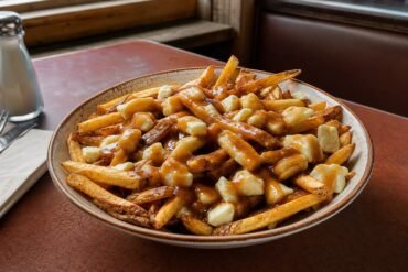 Quebec-style poutine with crisp fries, fresh cheese curds, and glossy brown gravy.