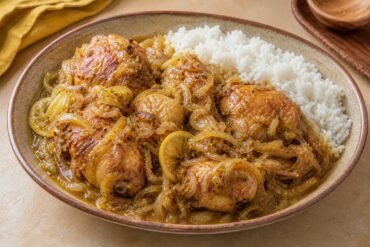 Senegalese chicken yassa with caramelized onions, lemon sauce, and white rice.