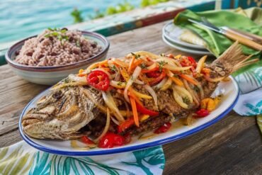 Jamaican escovitch fish topped with pickled onions, carrots, peppers, and Scotch bonnet.