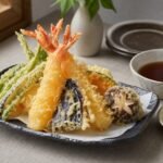 Crisp Japanese shrimp and vegetable tempura with tentsuyu dipping sauce, grated daikon, and lemon.