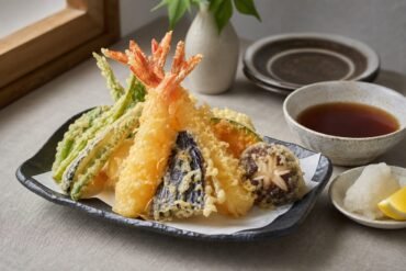 Crisp Japanese shrimp and vegetable tempura with tentsuyu dipping sauce, grated daikon, and lemon.