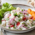 Peruvian ceviche with white fish, red onion, cilantro, chili, sweet potato, and lime.