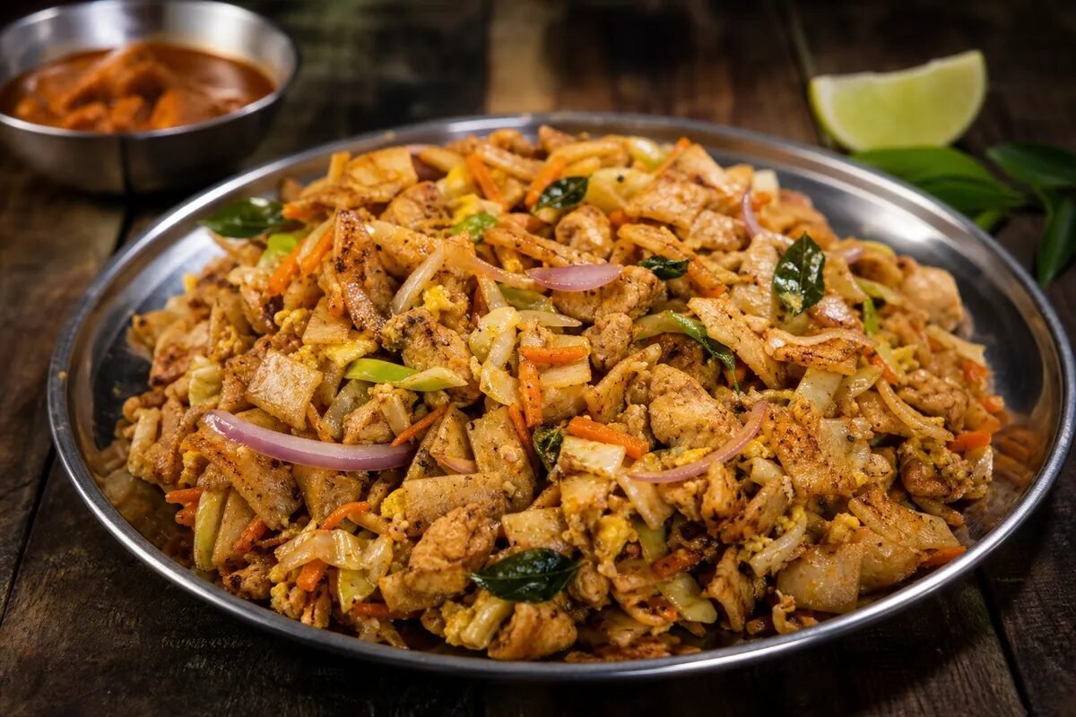 Sri Lankan chicken kottu roti with chopped flatbread, vegetables, egg, and curry leaves.