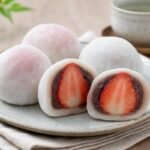 Japanese strawberry daifuku mochi with soft white shells, sweet red bean paste, and whole strawberry centers.