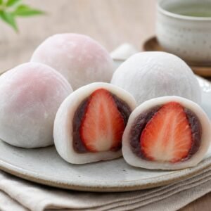Japanese strawberry daifuku mochi with soft white shells, sweet red bean paste, and whole strawberry centers.