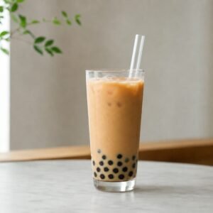 Taiwanese bubble milk tea with creamy black tea, ice, tapioca pearls, and a wide straw.