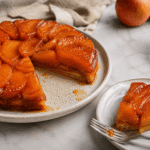A glossy French tarte Tatin with caramelized apples, flaky pastry, and crème fraîche.