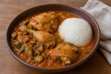 Angolan chicken muamba with okra, tomato sauce, and white funge.