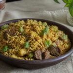 Bangladeshi bhuna khichuri with golden rice, moong dal, beef, fried onion, and cilantro.