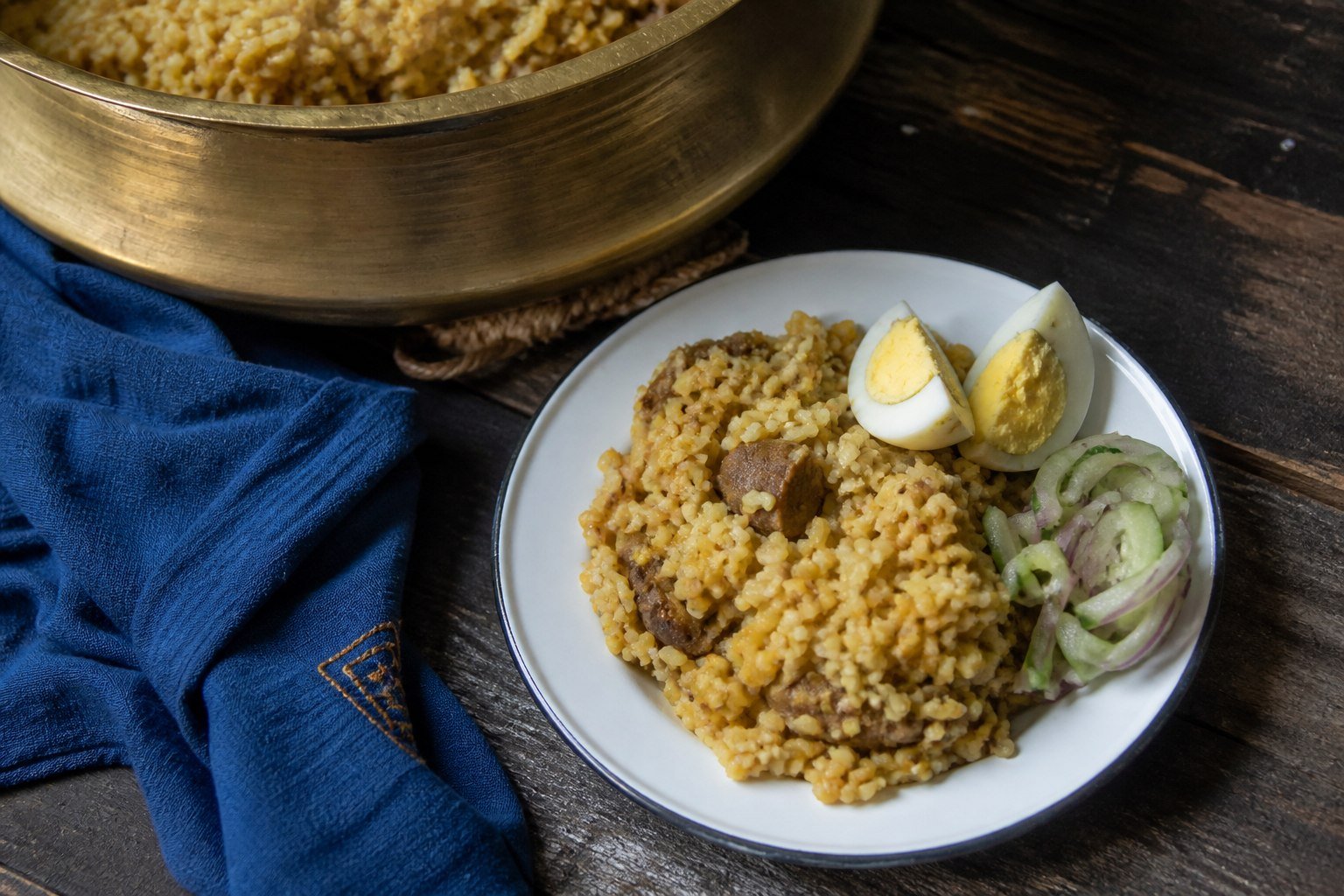 Bhuna khichuri served with boiled egg and cucumber-onion salad.