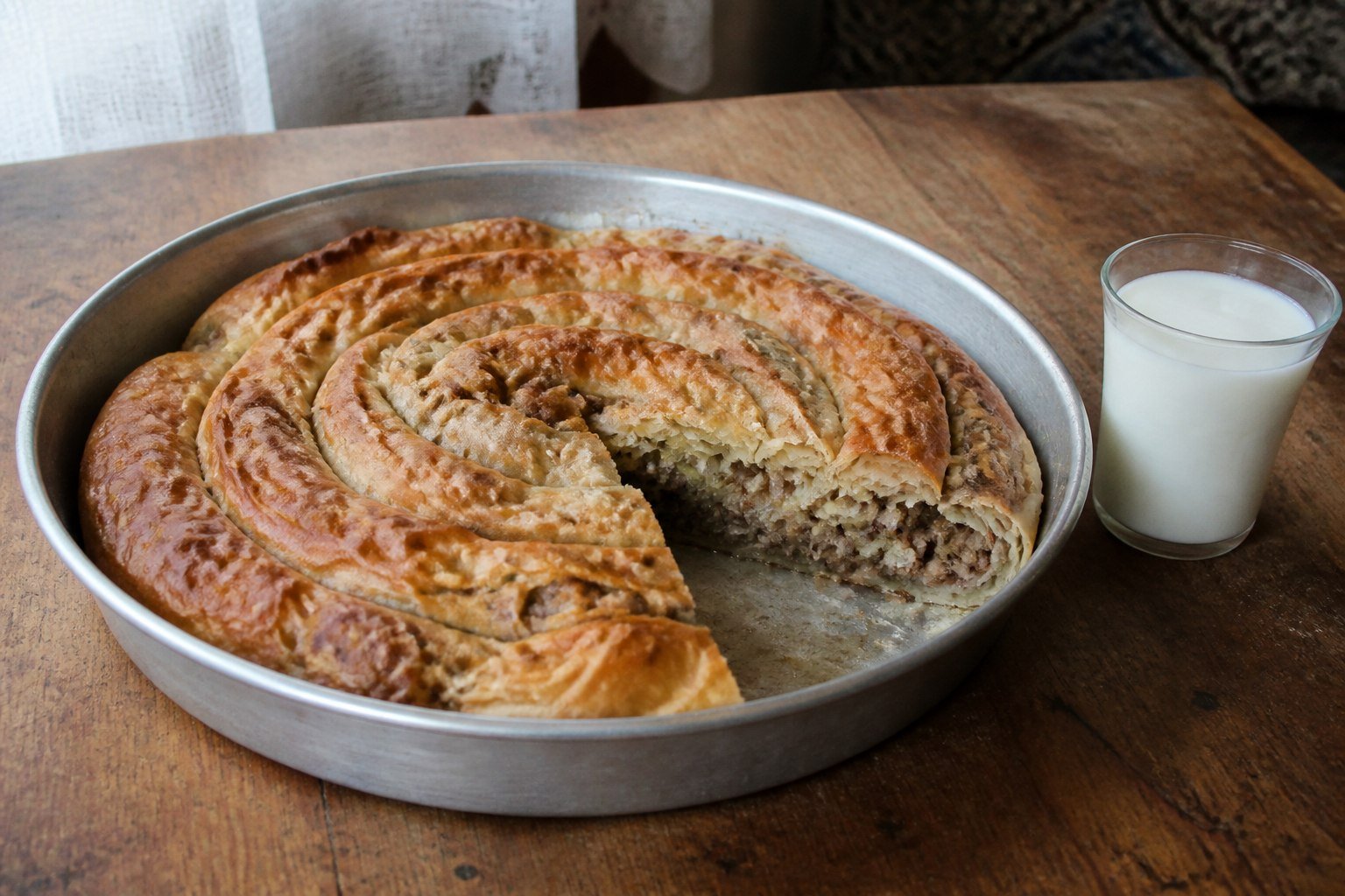 Bosnian beef burek baked in a spiral and served with yogurt.