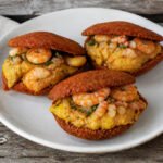 Brazilian acaraje fritters filled with vatapa, okra, vinaigrette, and shrimp.
