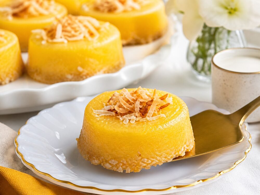 A Brazilian quindim coconut custard being served on a small dessert plate.