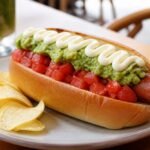 Chilean completo italiano topped with tomato, avocado, and mayonnaise.