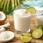 Chilled Colombian Limonada de Coco with lime, coconut, and a foamy top.