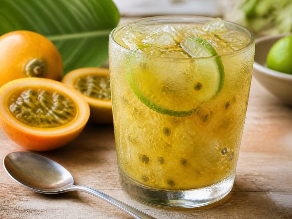 A condensation-covered glass of Colombian lulada with crushed lulo pulp and lime.