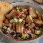 Costa Rican chifrijo with rice, red beans, pork-belly chicharron, pico de gallo, avocado, and chips.