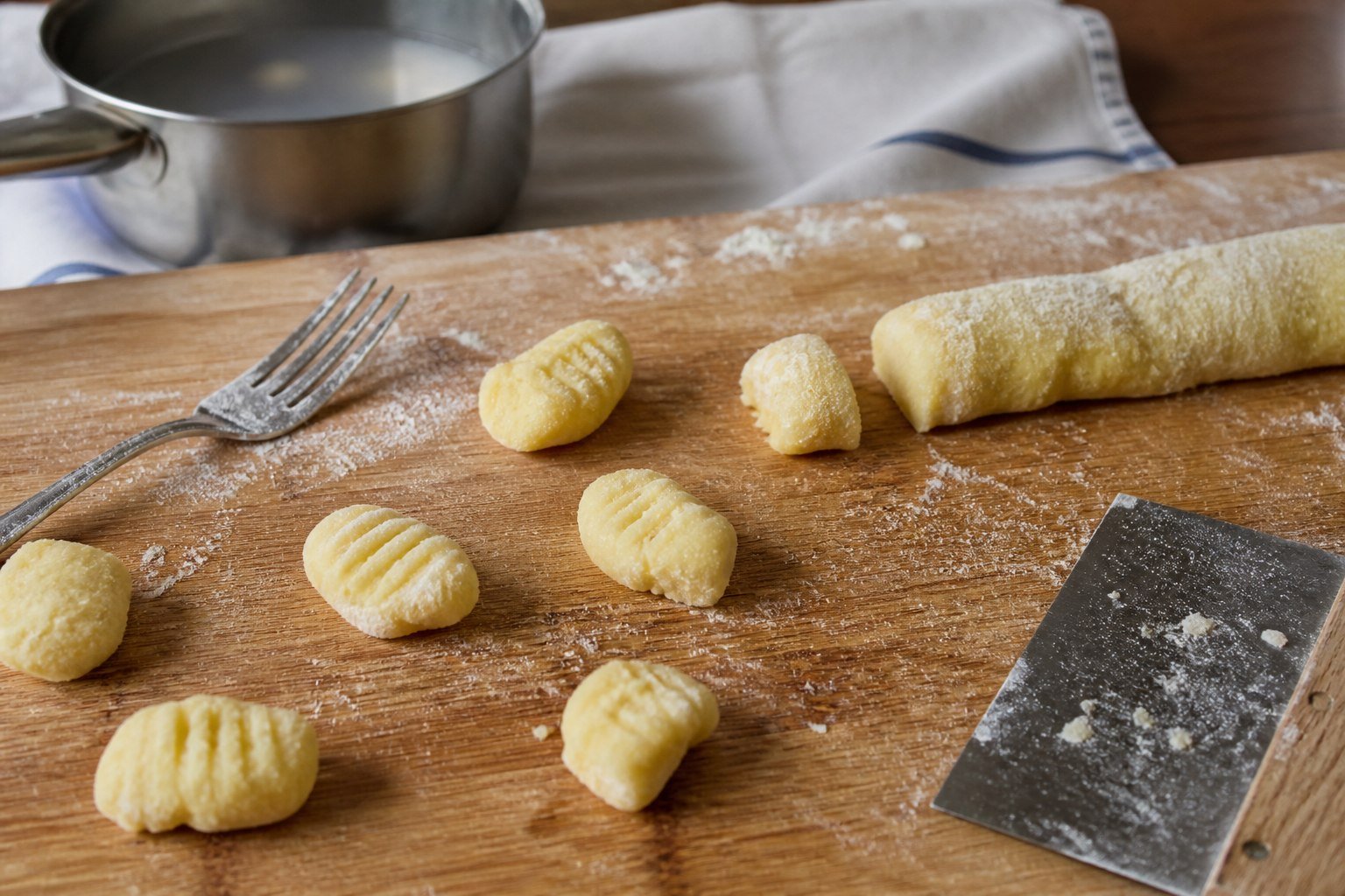 Homemade potato gnocchi being shaped for Croatian pasticada.
