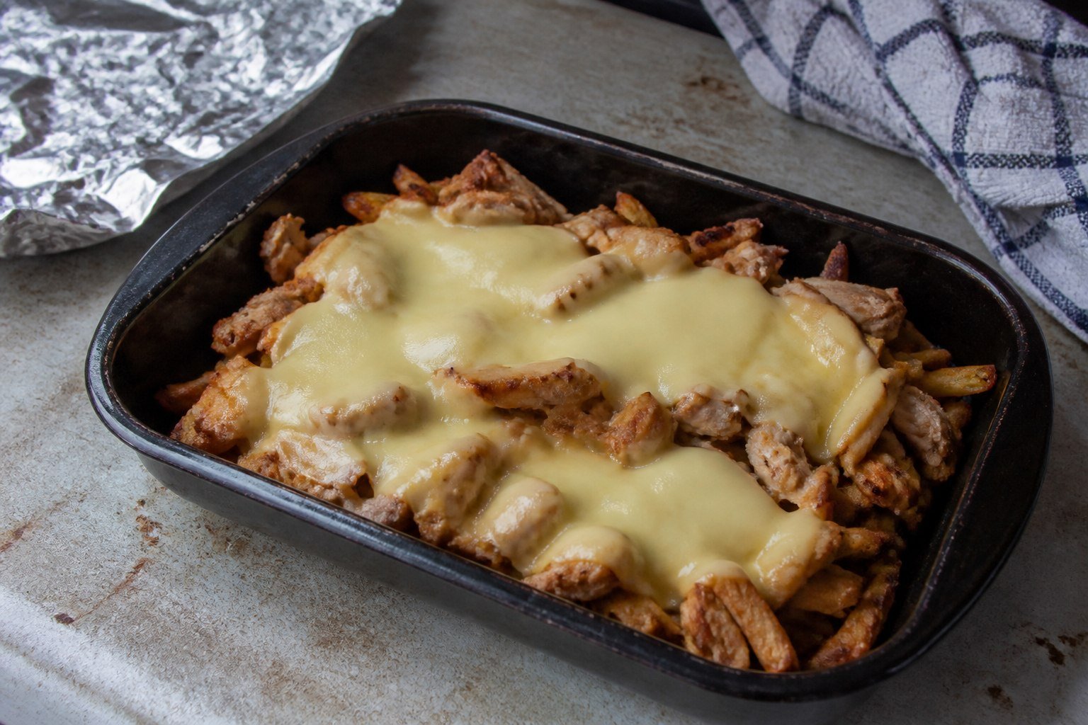 Fries and shawarma chicken baked under melted Gouda for Dutch kapsalon.