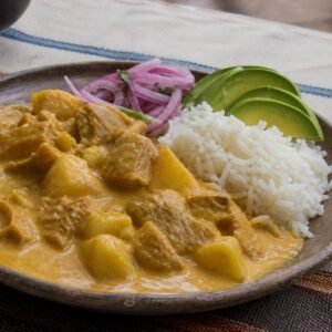 Ecuadorian guatita tripe and potato stew with rice, avocado, and pickled onion.