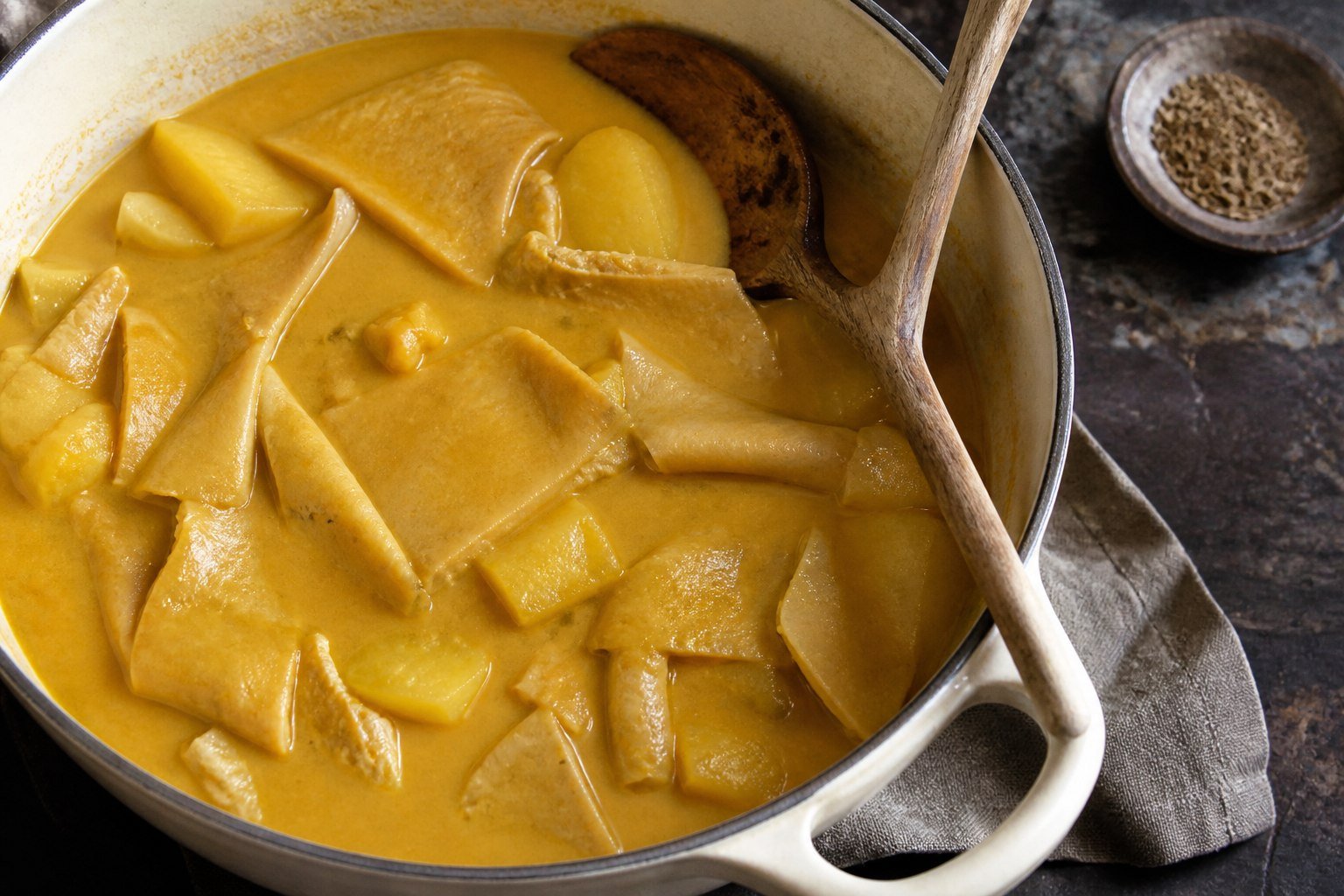 Ecuadorian guatita simmering in a smooth peanut sauce with potato and tripe.