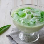 Filipino buko pandan dessert with young coconut and green pandan jelly.