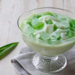 Filipino buko pandan dessert with young coconut and green pandan jelly.