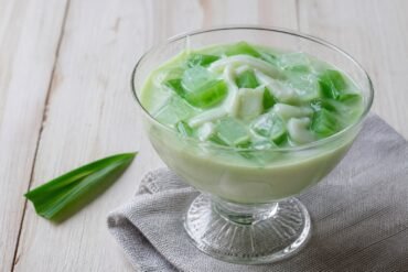 Filipino buko pandan dessert with young coconut and green pandan jelly.