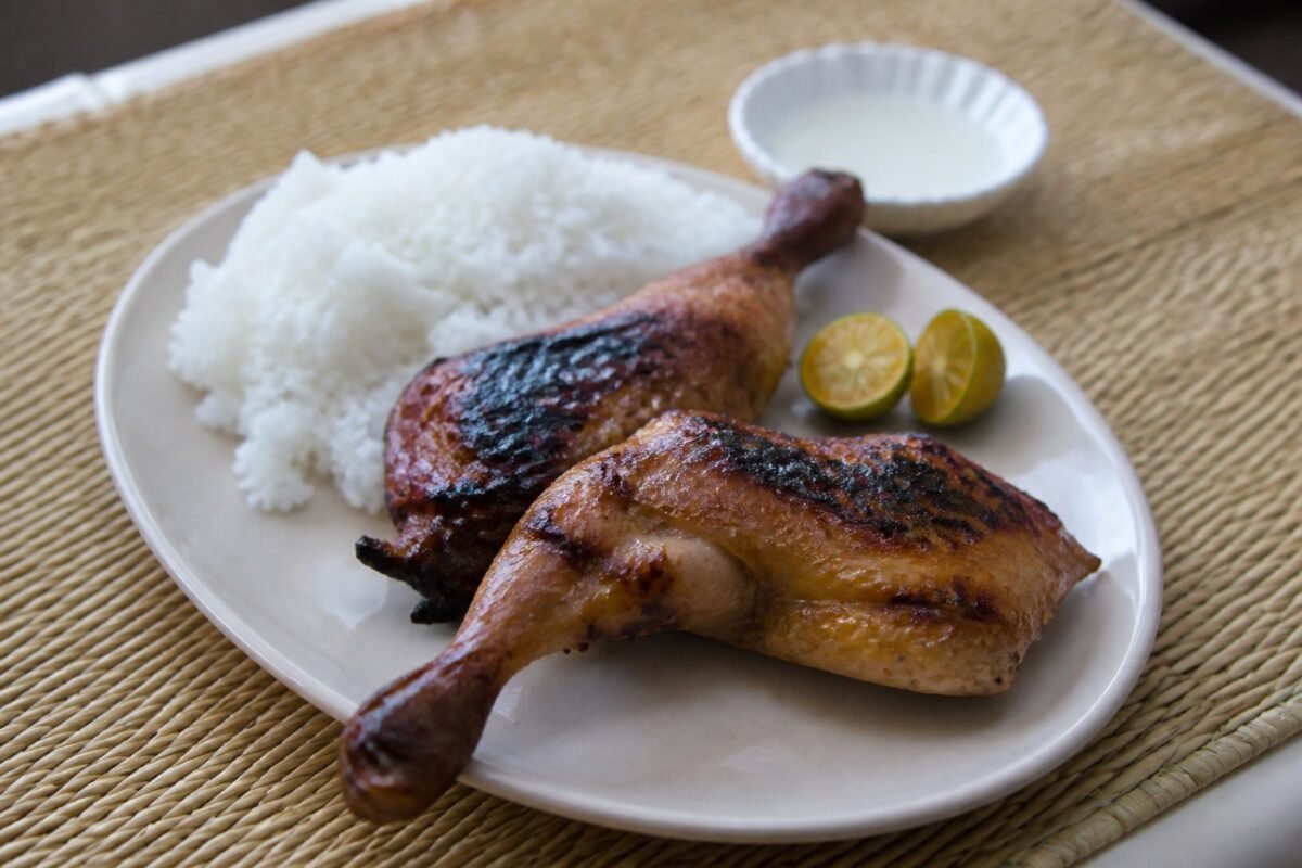 Filipino chicken inasal with steamed rice, calamansi, and vinegar.