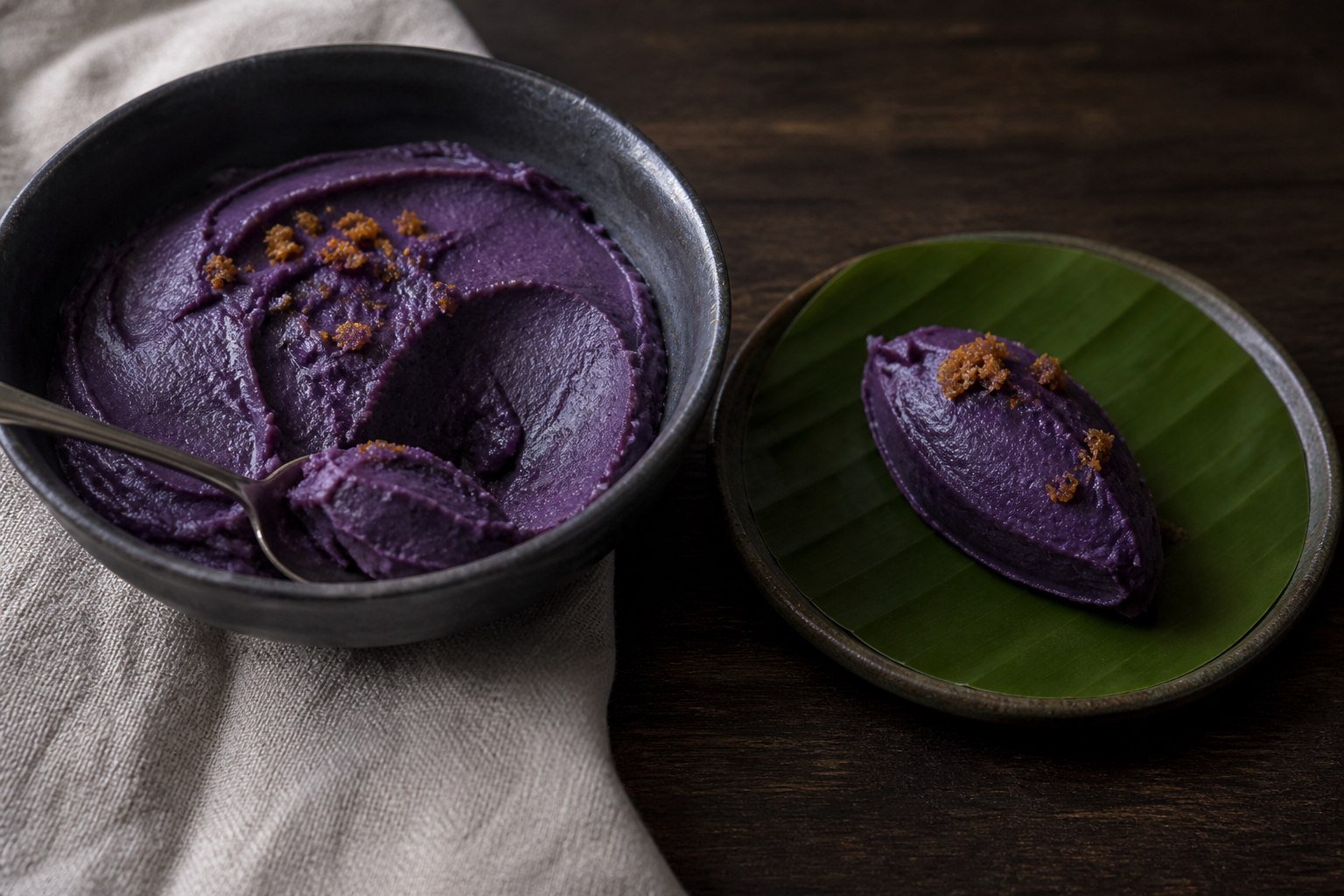 Filipino ube halaya served from a bowl onto a banana-leaf-lined plate.