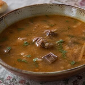 Georgian kharcho beef soup with rice, walnuts, sour plum, and coriander.