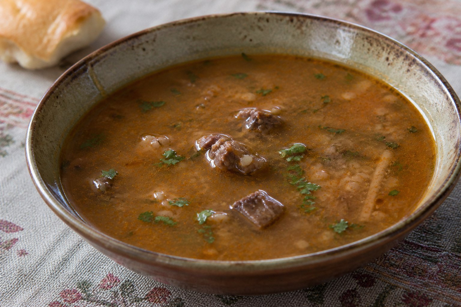 Georgian kharcho beef soup with rice, walnuts, sour plum, and coriander.