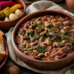Georgian lobio red bean stew with walnuts, coriander, garlic, herbs, pickles, and crusty bread.