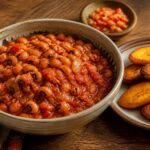 Ghanaian red red black-eyed pea stew with red palm oil, tomato, and fried ripe plantains.