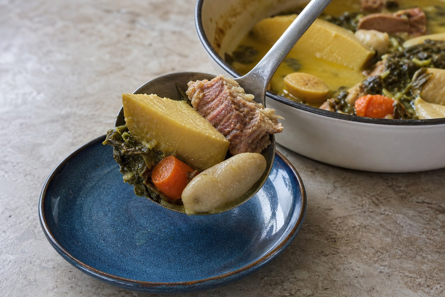 Grenadian oil down being served from a pot with breadfruit, callaloo, dumpling, carrot, and salted meat.