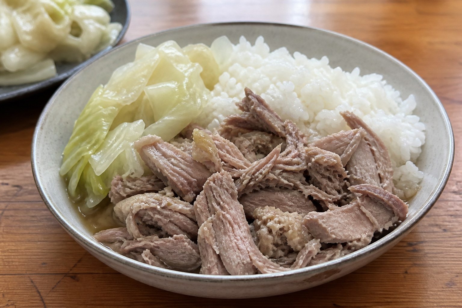 Hawaiian kalua pork served with steamed rice and tender cabbage.