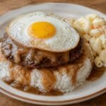 Hawaiian loco moco with rice, beef patty, onion gravy, fried egg, and macaroni salad.