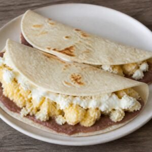Honduran baleadas filled with refried beans, egg, cheese, and crema.