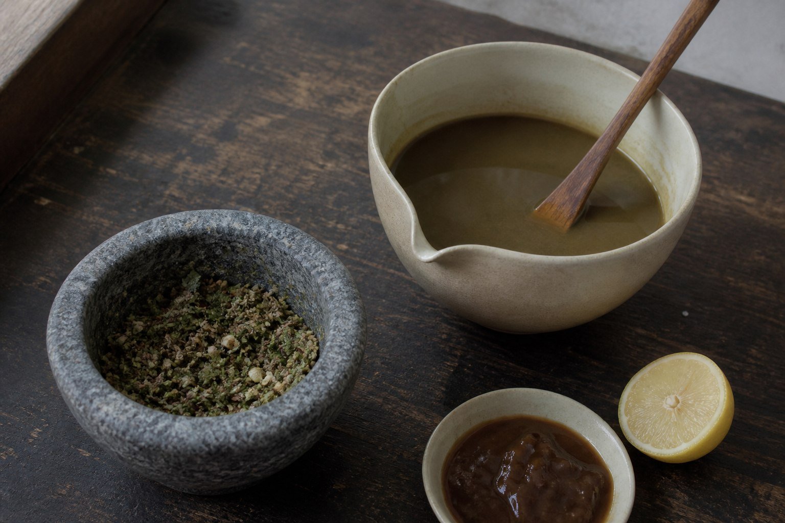 Roasted cumin, herbs, tamarind, lemon, and jaljeera mixture arranged on a home kitchen worktop.