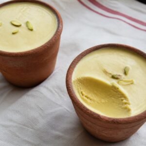 Indian pistachio kulfi served in clay cups with saffron and cardamom.