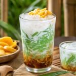 Indonesian Es Cendol with green pandan jelly, coconut milk, palm sugar, ice, and jackfruit.