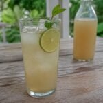 Cloudy homemade Jamaican ginger beer with lime and ice.