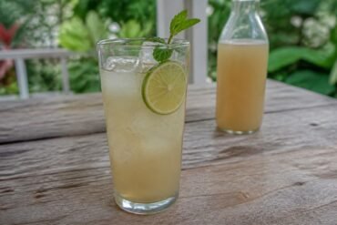 Cloudy homemade Jamaican ginger beer with lime and ice.