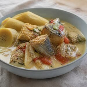 Jamaican mackerel rundown in coconut sauce with tomato, onion, and boiled green banana.