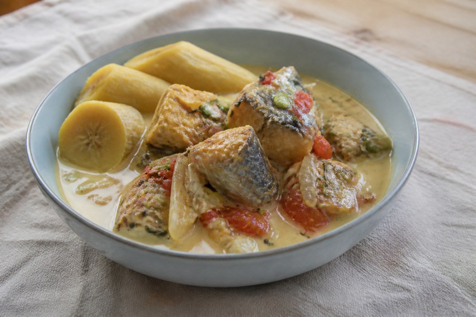 Jamaican mackerel rundown in coconut sauce with tomato, onion, and boiled green banana.