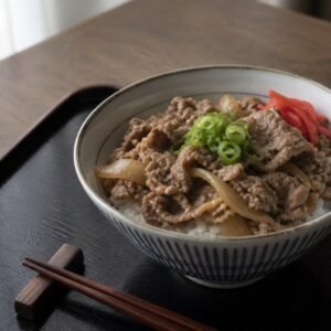 Japanese gyudon with thin simmered beef and onions over rice.