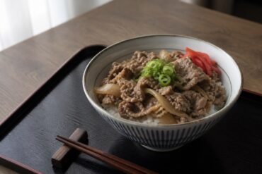 Japanese gyudon with thin simmered beef and onions over rice.