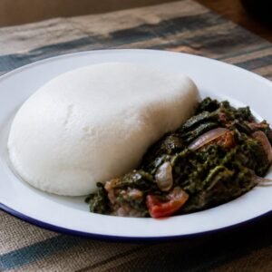 Kenyan maize ugali served with sautéed sukuma wiki, onions, and tomatoes.